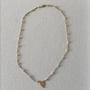 Gold pearl necklace with angel charm